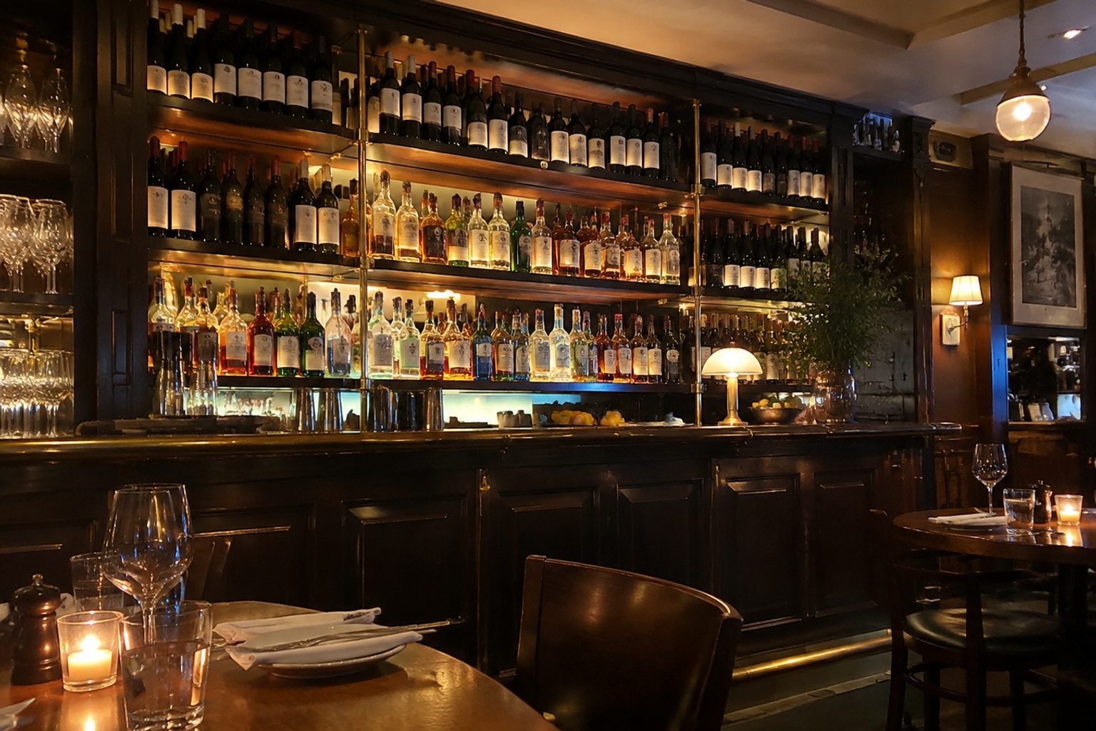 The back bar shelf — dark wood and brass