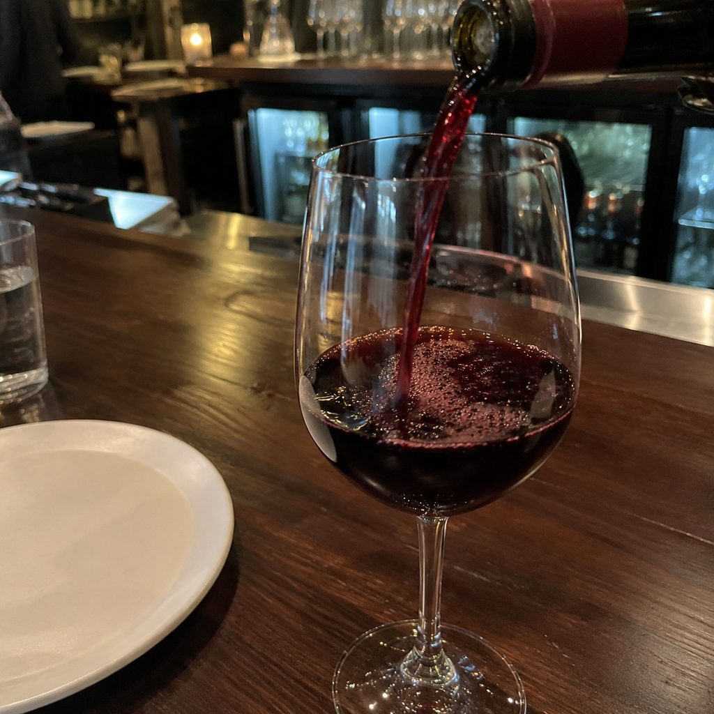 Red wine poured at the bar — see the pours